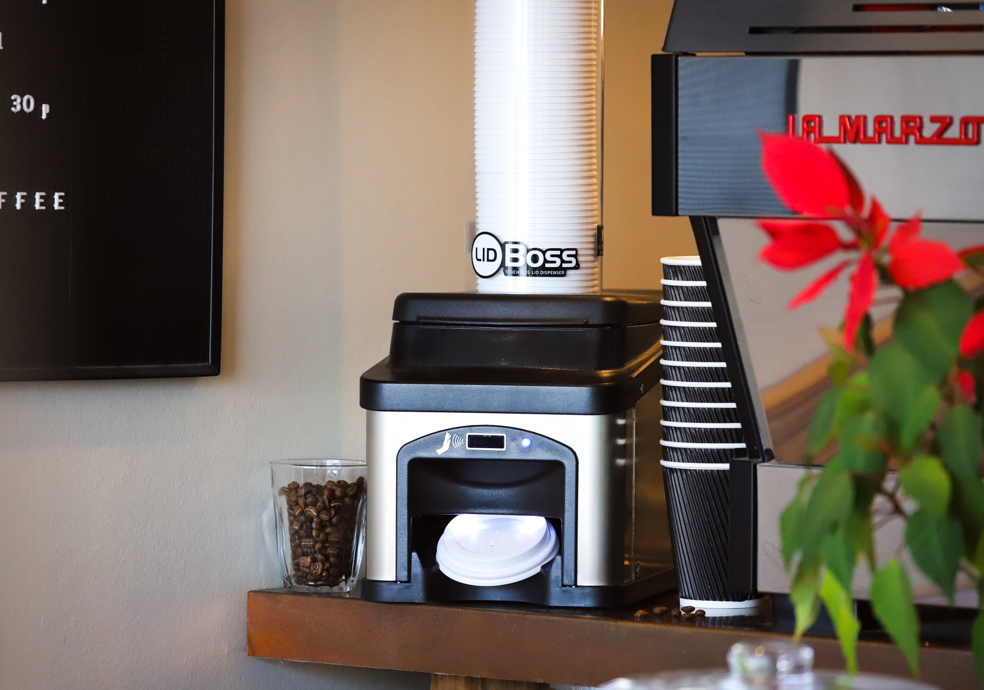 Lid Boss dispenser in use at coffee shop